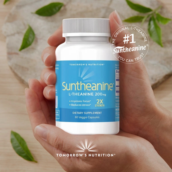 Hand holding a bottle of Suntheanine supplement with a natural background